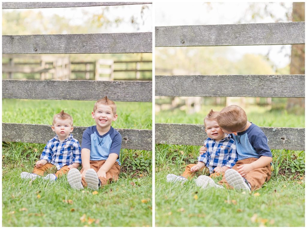 two lttle brothers posing for photos in front of fence