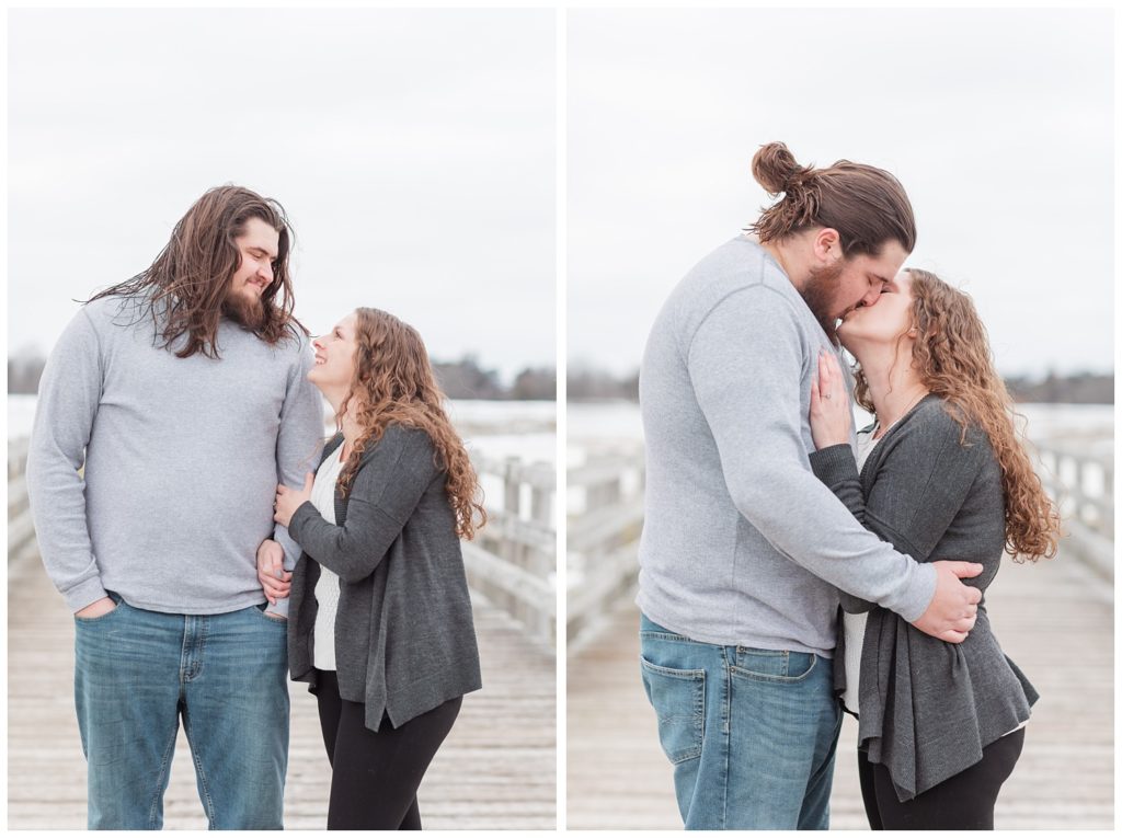 couple looking at each other and kissing on a deck during engagement session