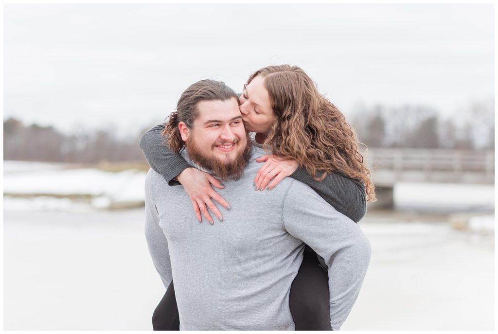 guy carrying a girl on his back during Ohio engagement session