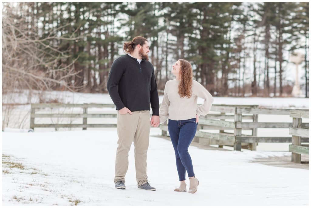 couple holding hands posing in the snow in Ohio