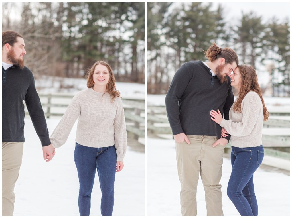 couple holding hands and posing for engagement session in snow