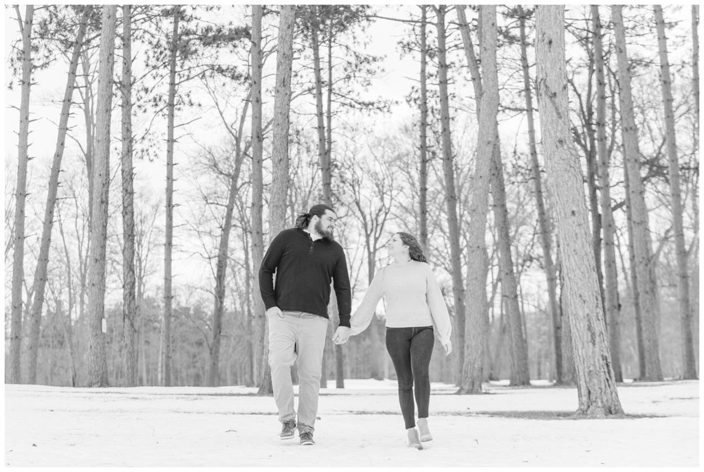 black and white photo of couple walking together in snow in Ohio