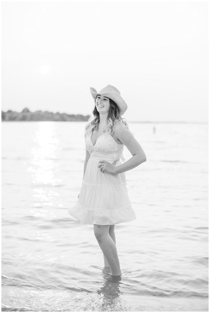 girl standing next to a lake posing for senior photos on Ohio