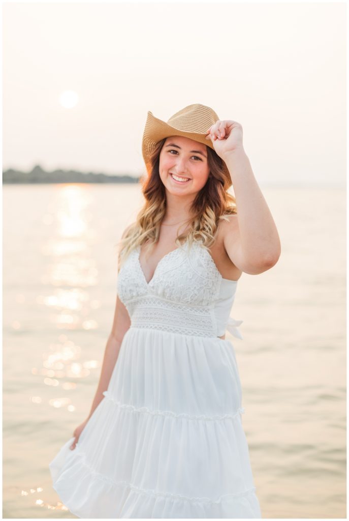 girl wearing a cowboy hat next to a lake in Ohio
