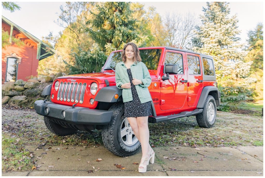 girl posing in front of her red jeep in Ohio