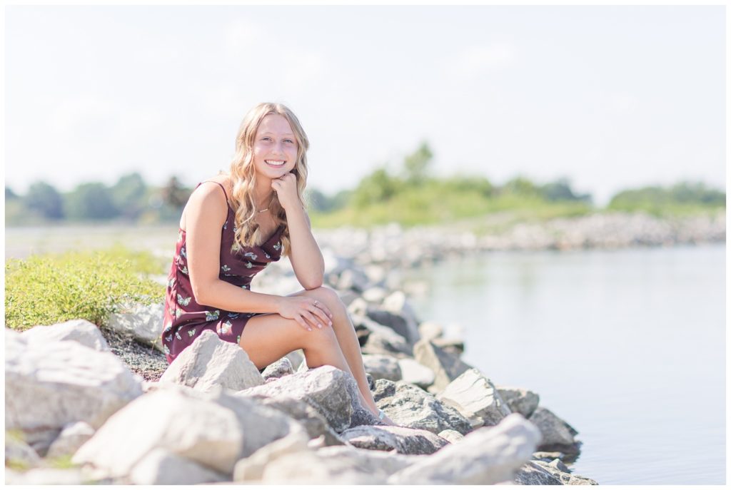 girl posing on rocks next to a lake in Ohio
