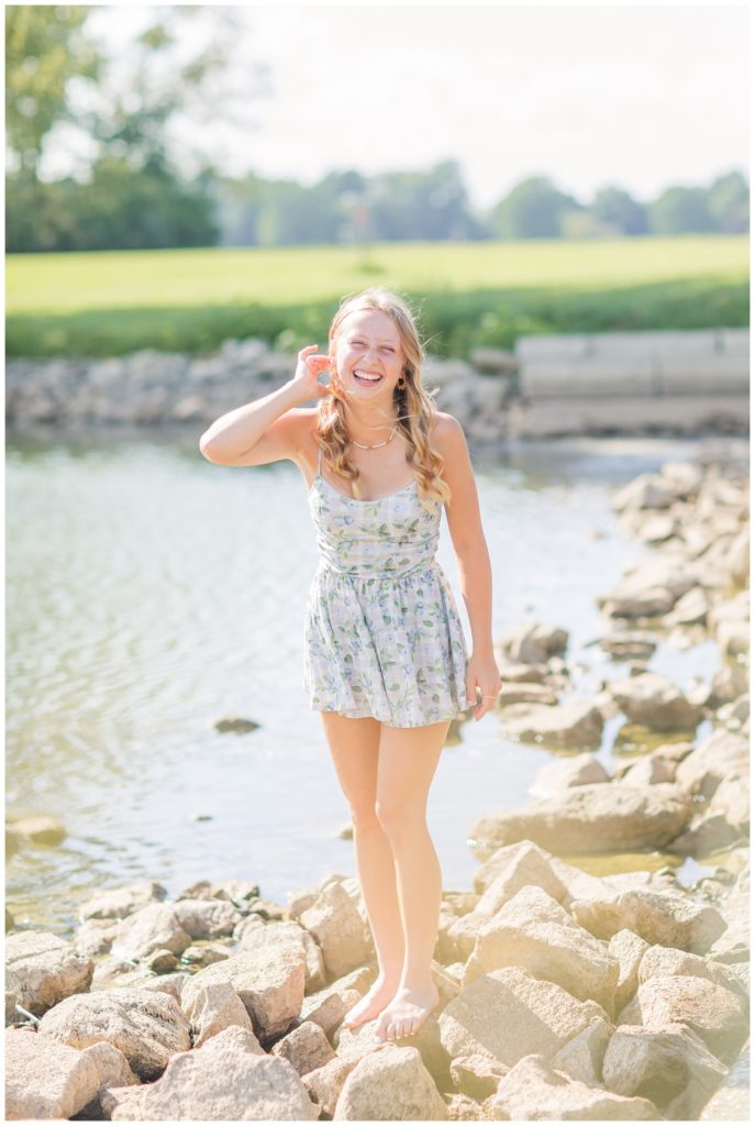 girl laughing at the camera standing on rocks in Ohio