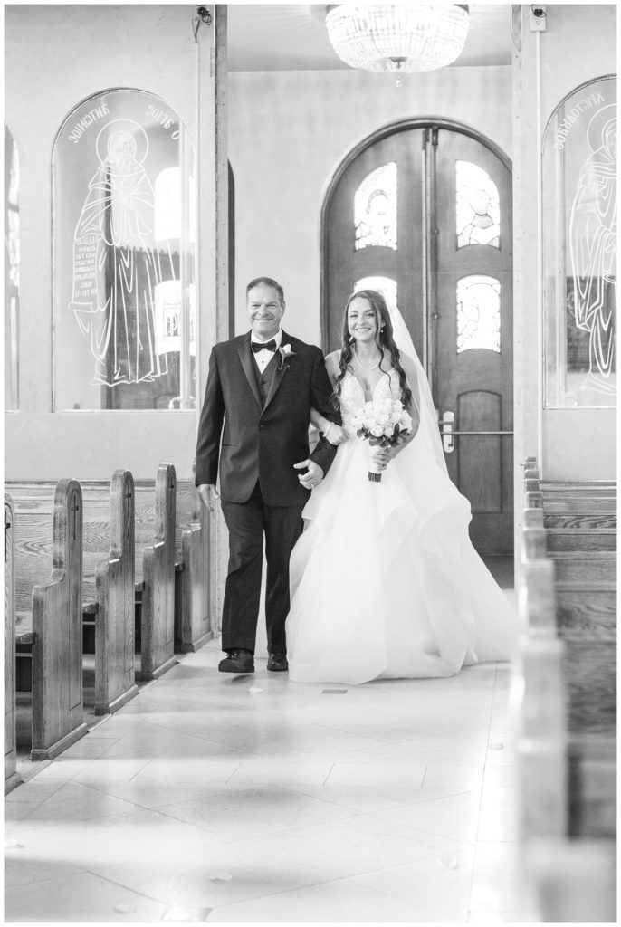 bride walking down the aisle with her dad at Greek Orthodox church in Ohio