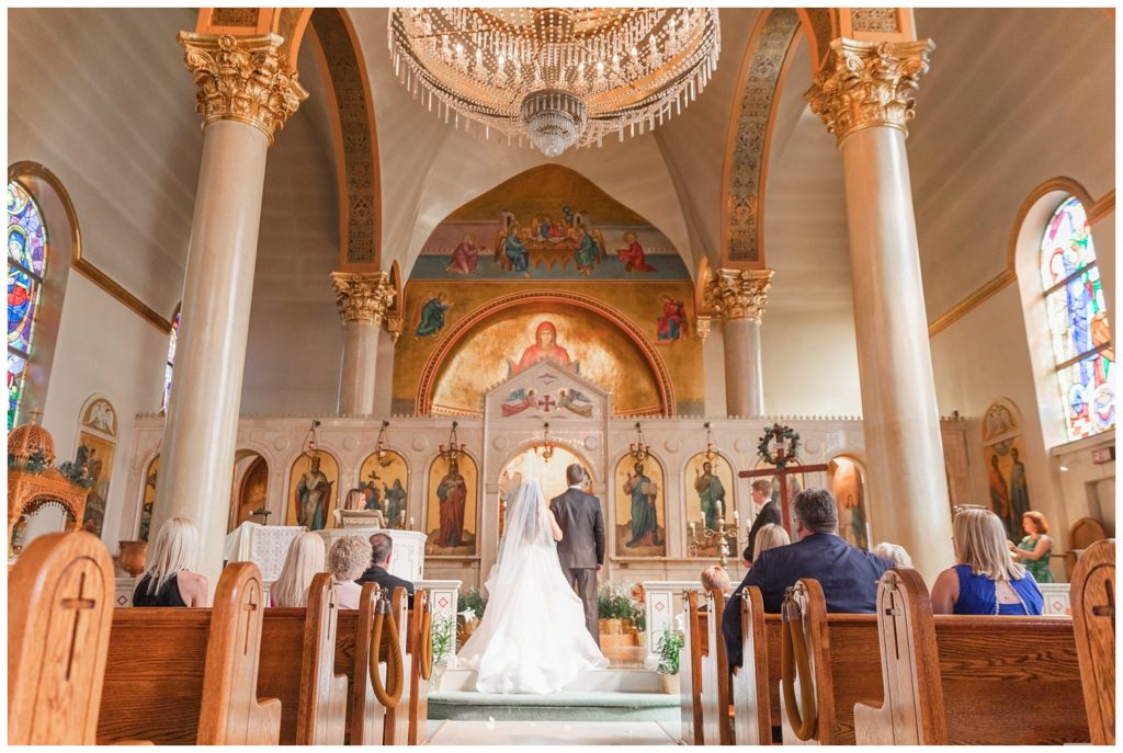 wide shot of bride and groom during Greek Orthodox wedding