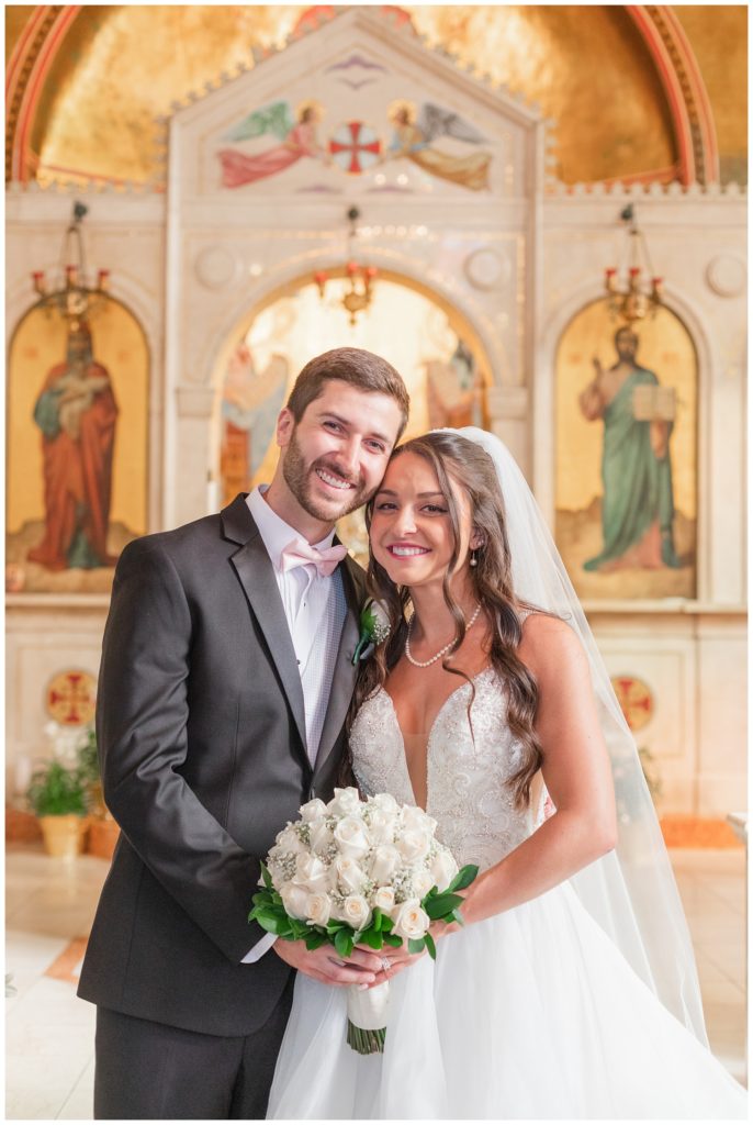 bride and groom smiling at camera at Ohio Greek wedding