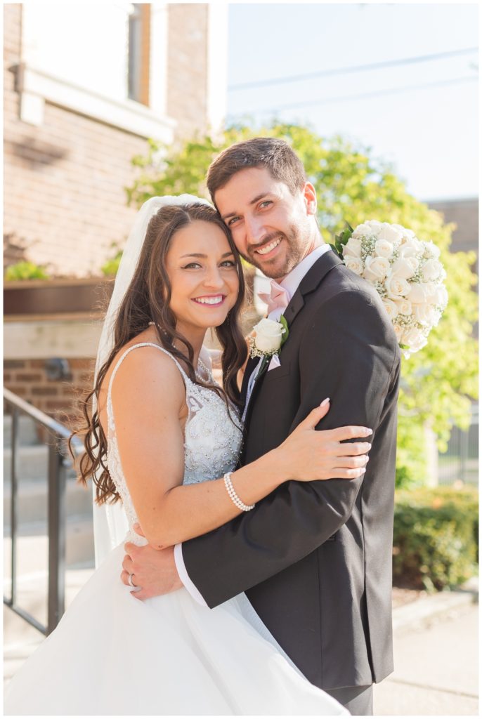 bride and groom posing together at Greek wedding 