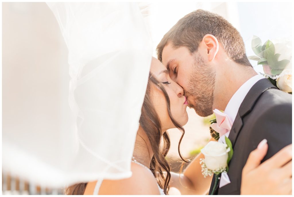 bride and groom kissing under the veil at Ohio Greek wedding
