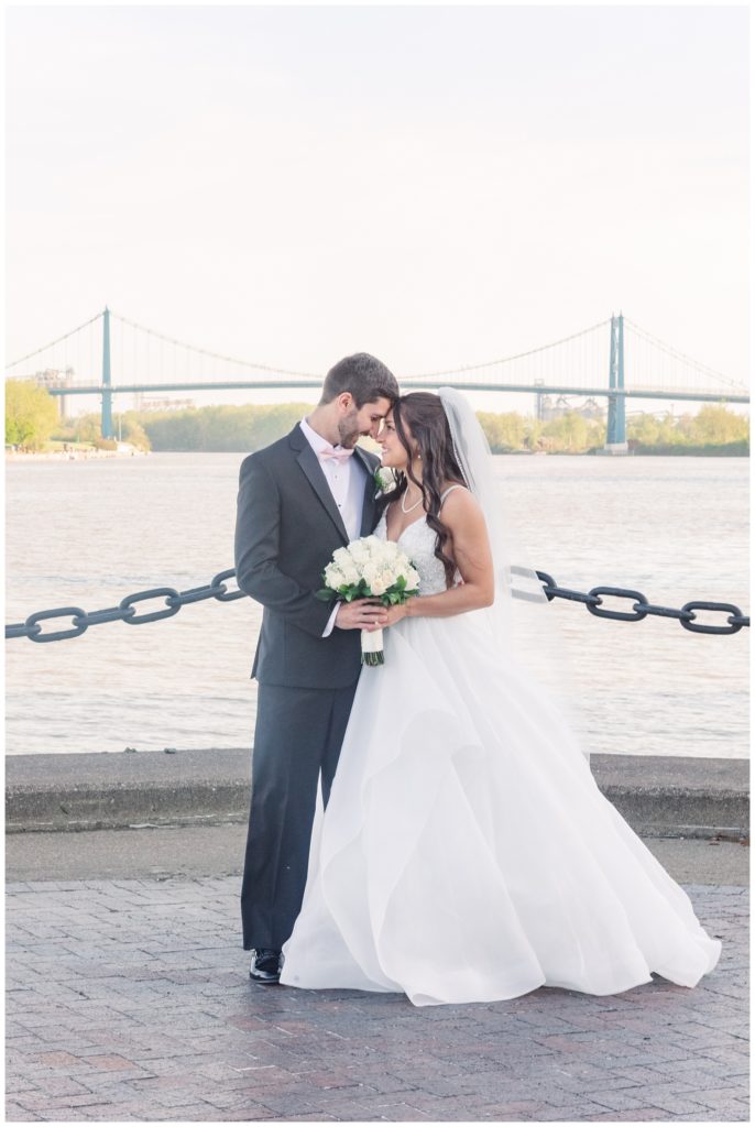 bride and groom posing at waterfront in Toledo, Ohio