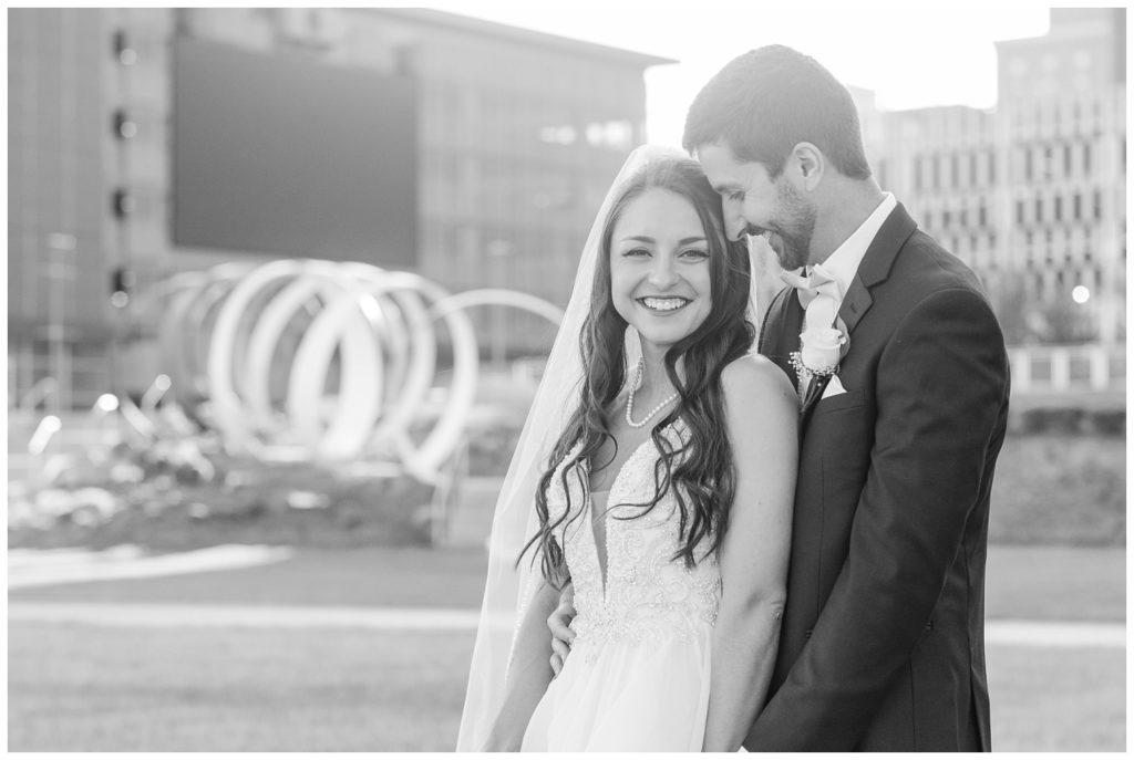 bride and groom posing together in downtown Ohio