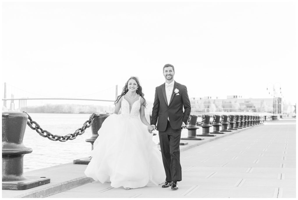bride and groom walking together at pier in Toledo, Ohio