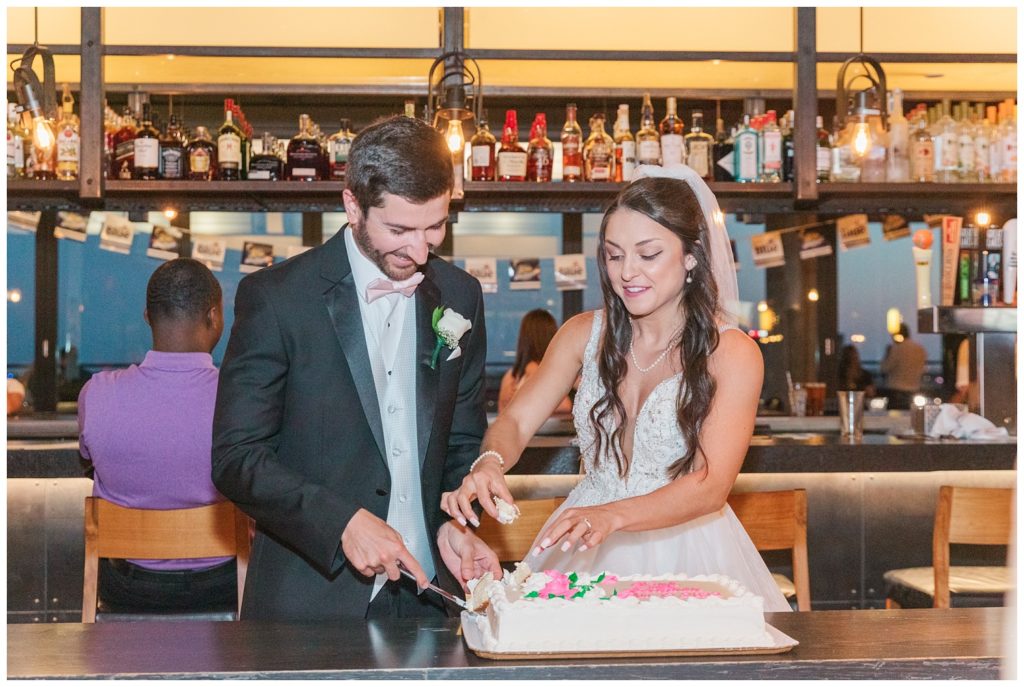 bride and groom cutting cake at their wedding dinner in Toledo