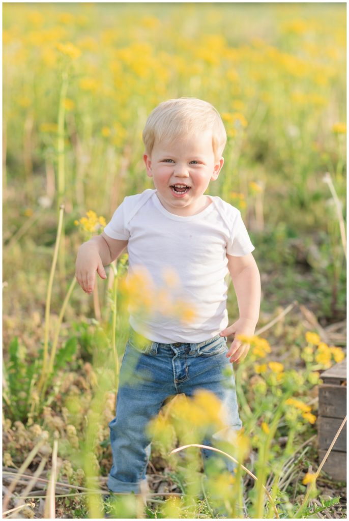 boy laughing in a yellow field in Ohio