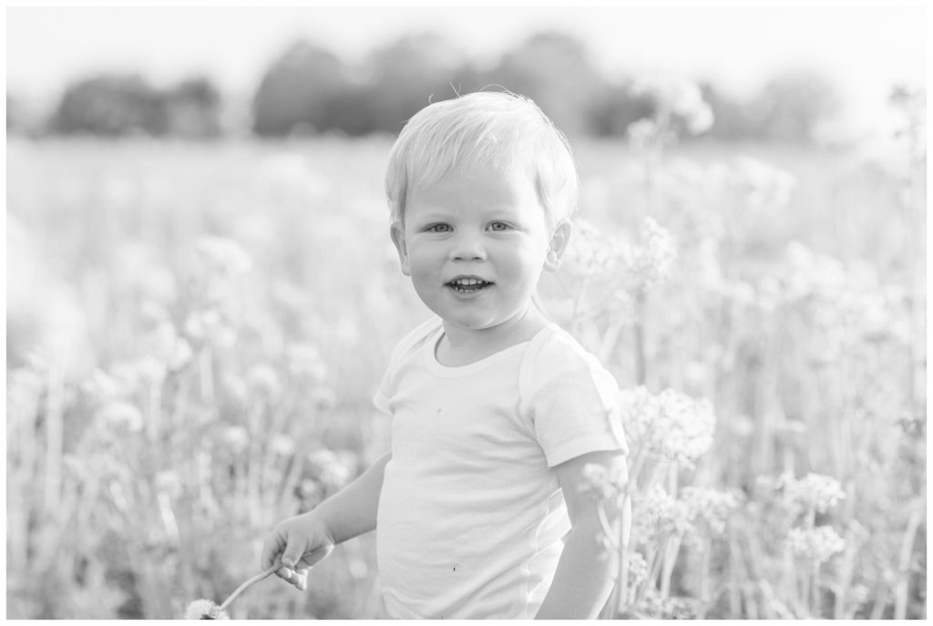 boy smiling at the camera while standing in a field in Ohio