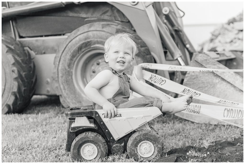 boy sitting in a Tonka toy truck posing for birthday photos in Ohio
