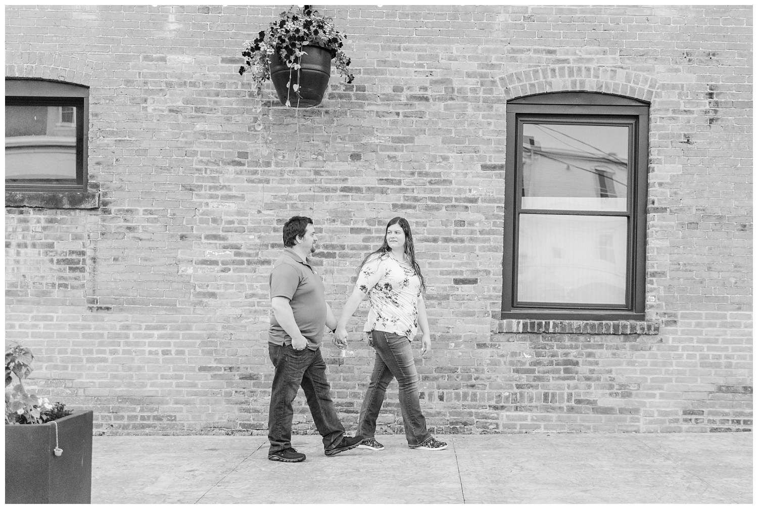 couple holding hands and walking together for engagement session