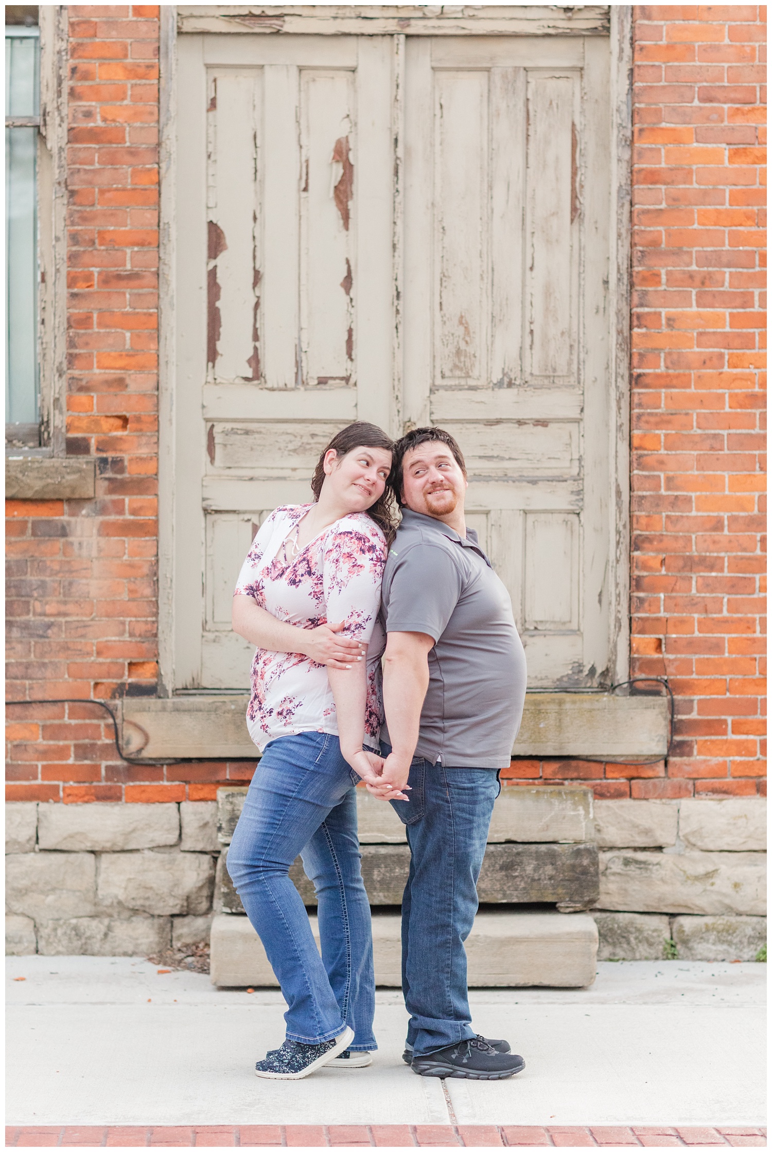 couple posing back to back for engagement photos