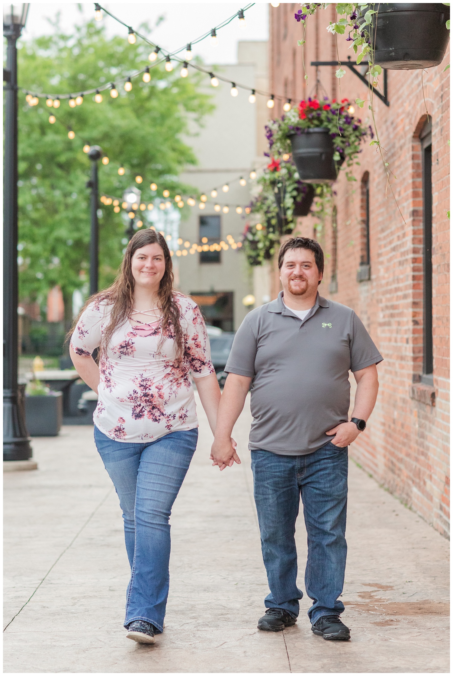 couple walking and holding hands for engagement session