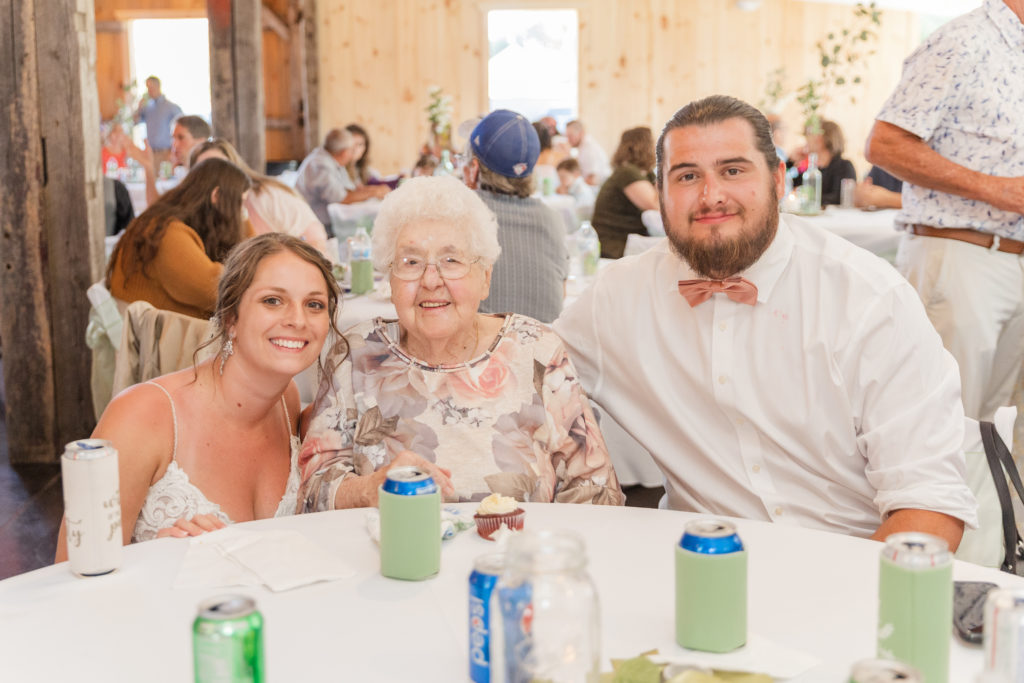 bride and groom sitting with grandma at the Village Barn venue in Ohio