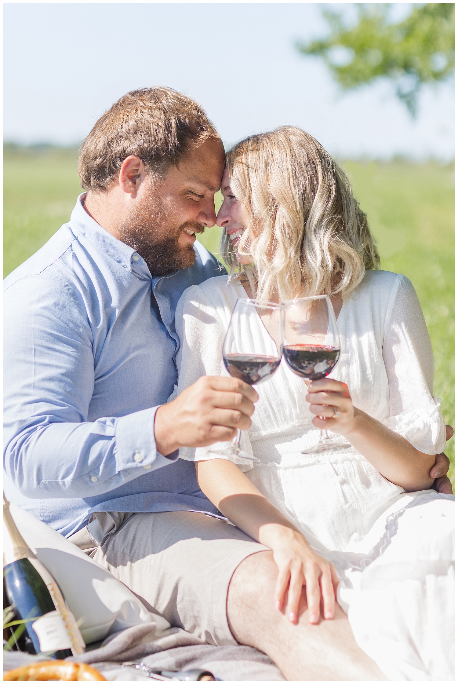 couple toasting with wine during engagement session in Ohio