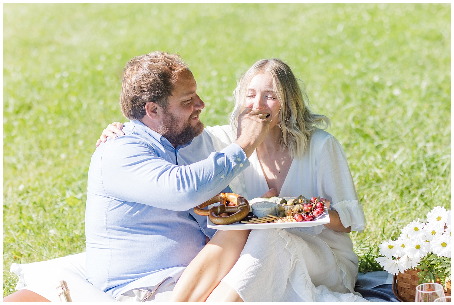 couple eating charcuterie during engagement session