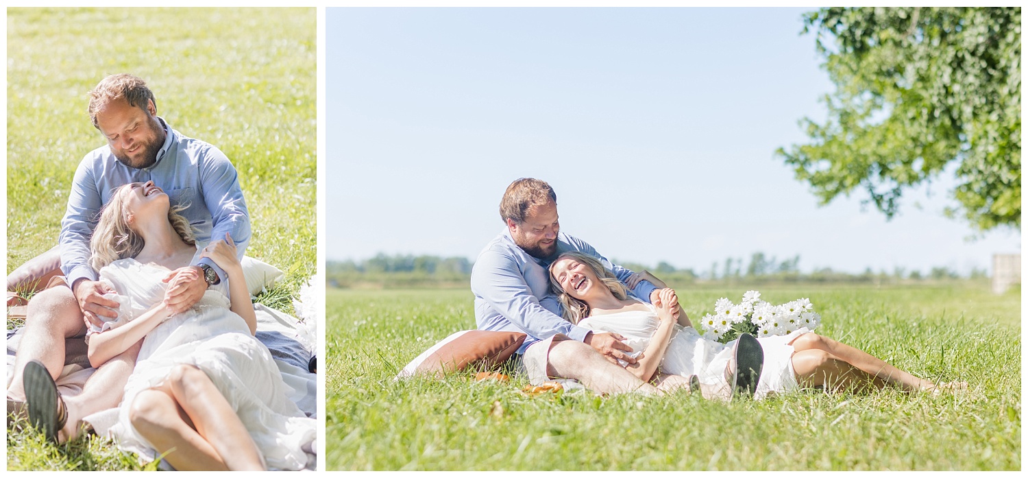 couple laying in a field during engagement session