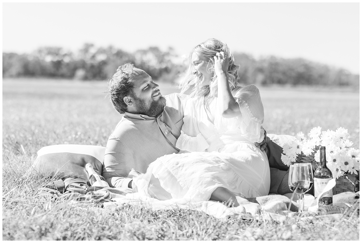 couple sitting together on a blanket in a field in Ohio