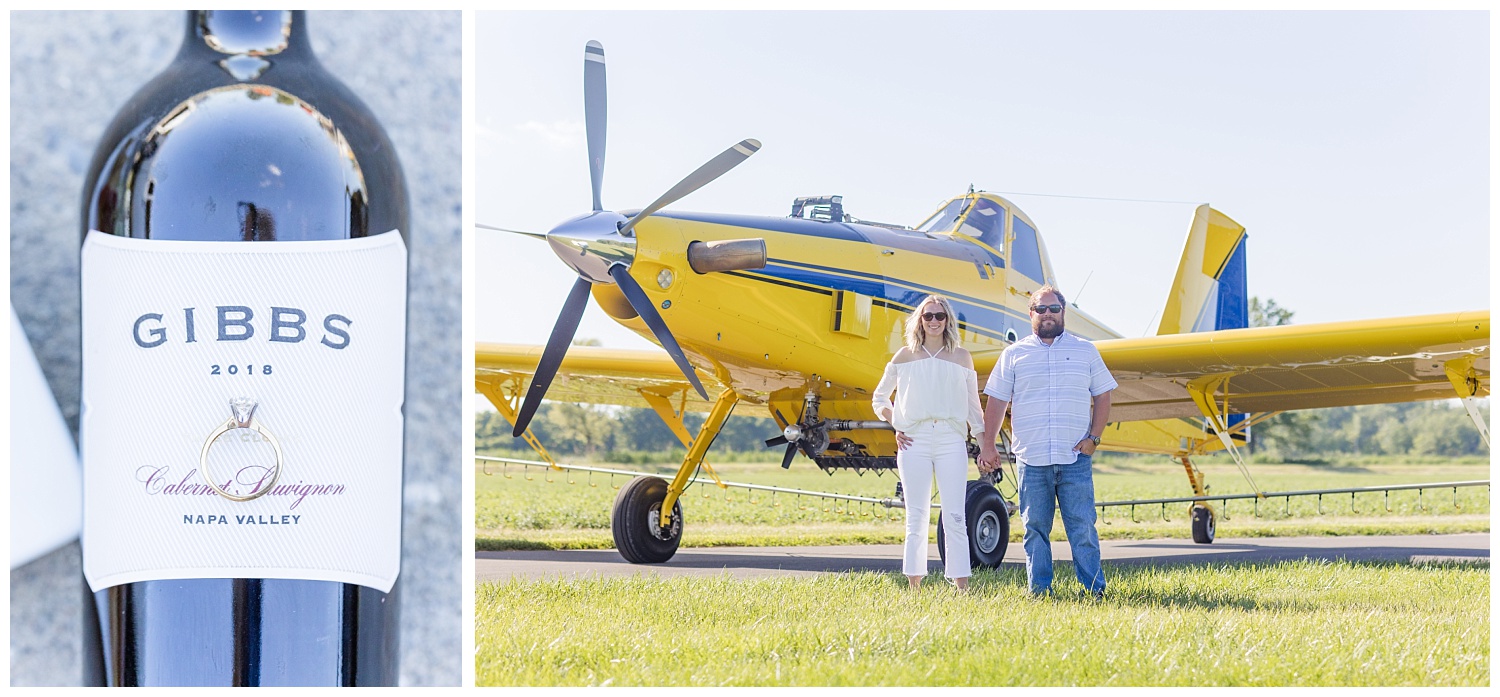 couple standing in front of a yellow airplane in a field 
