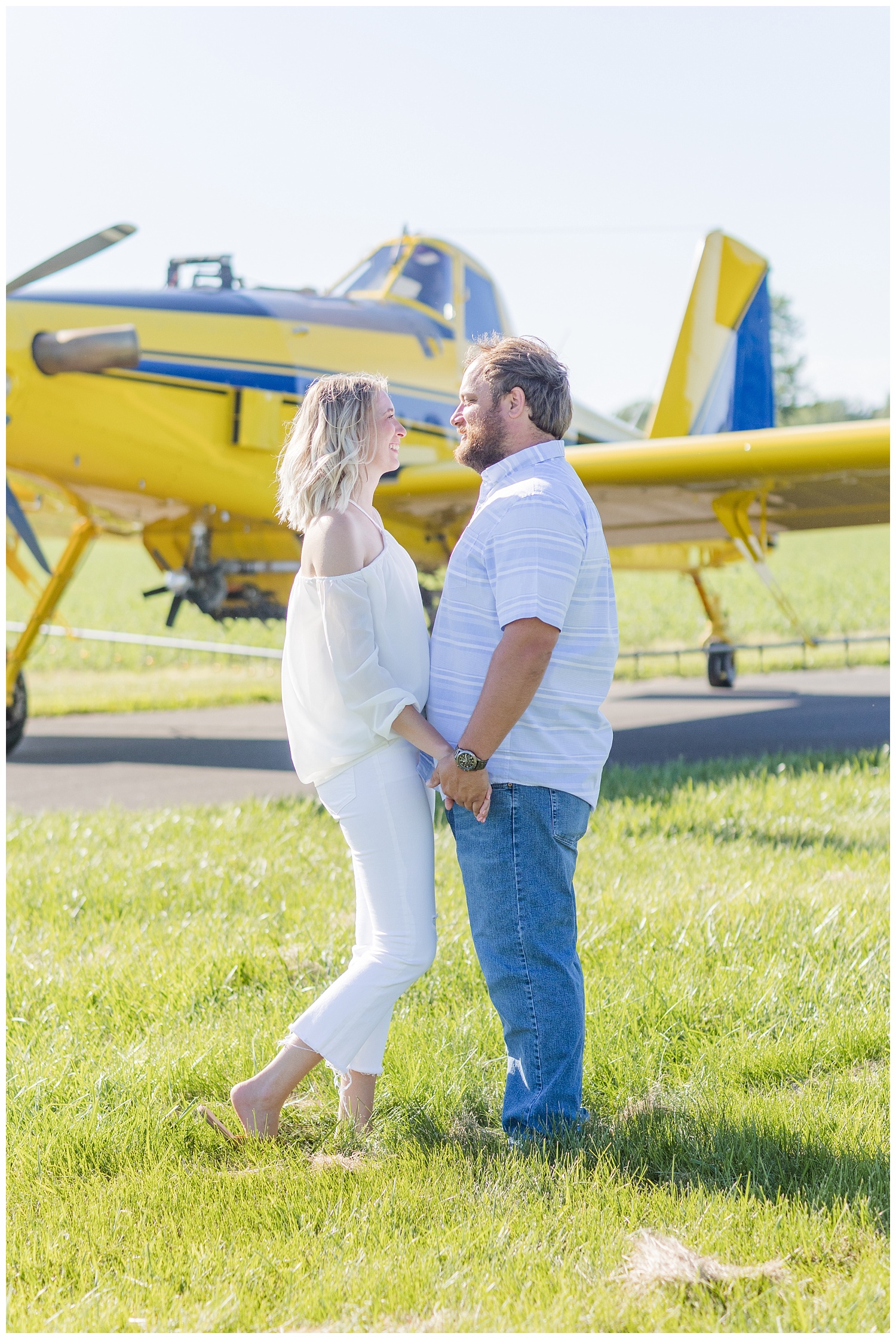 couple holding hands in front of an airplane in Ohio
