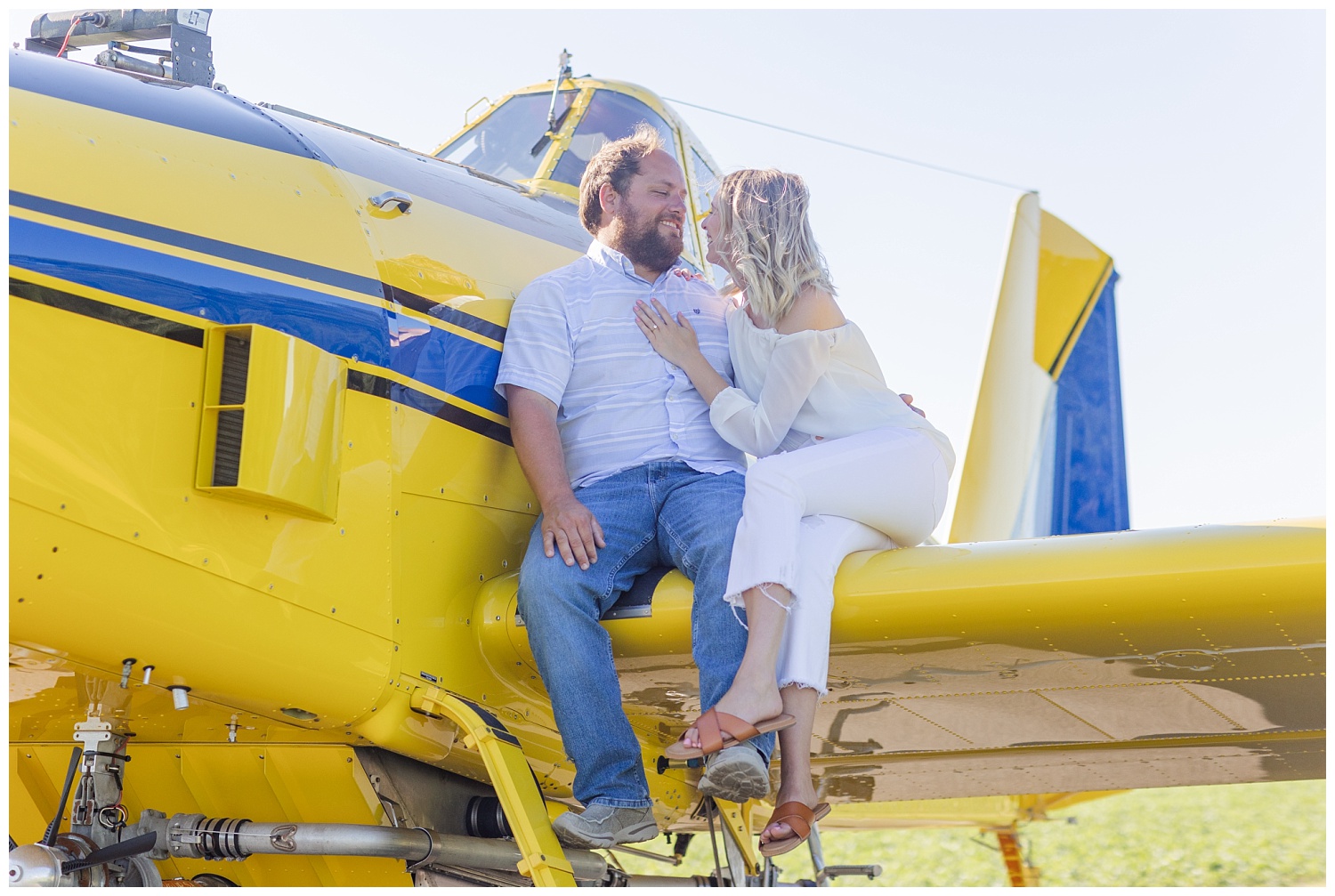 couple sitting on a yellow airplane wing in Ohio