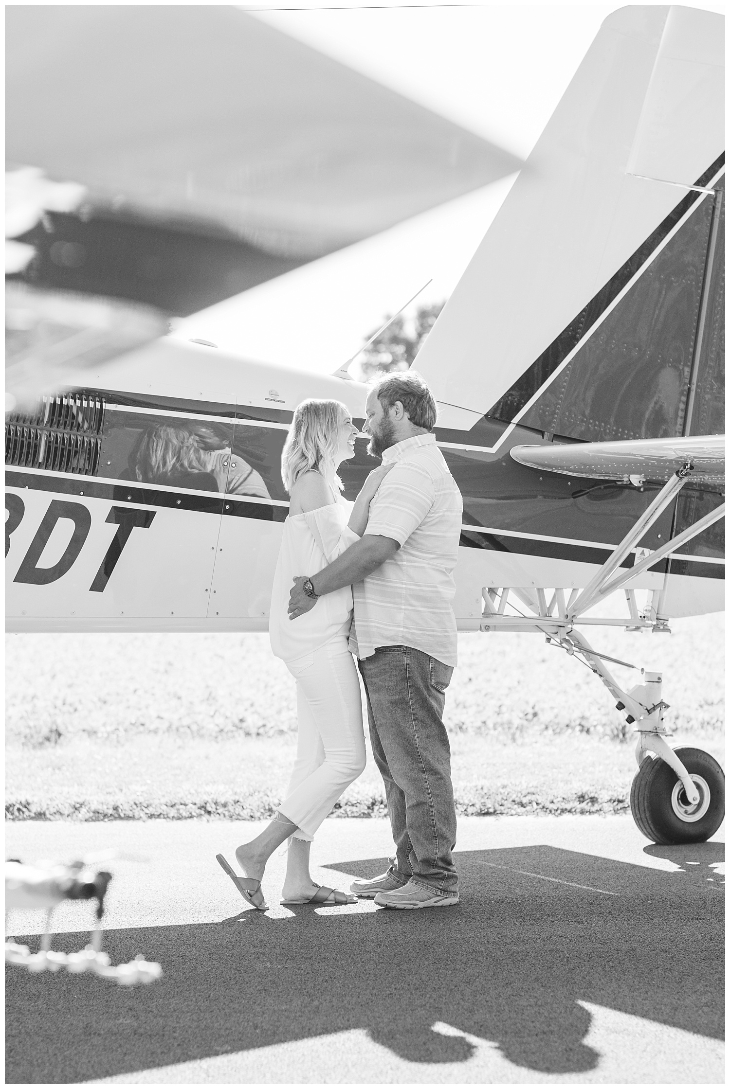 couple standing together in front of an airplane in Ohio