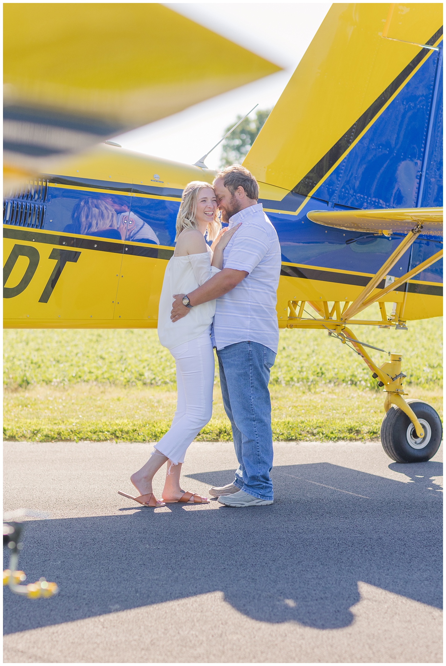 couple laughing during airplane engagement session in Ohio