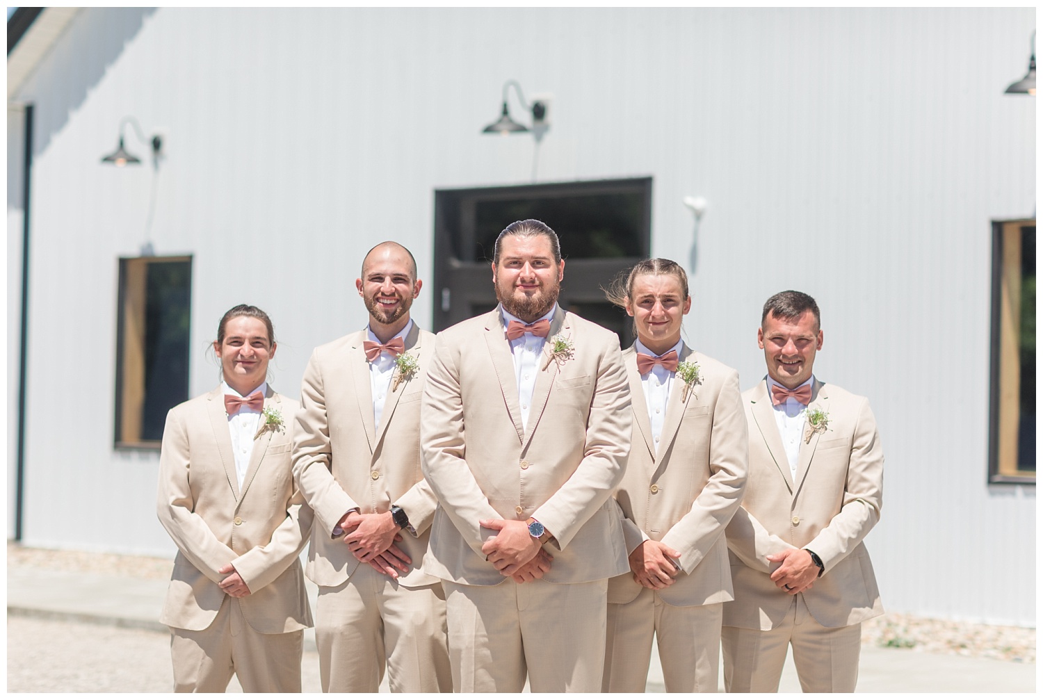 groomsmen posing together outside the wedding venue