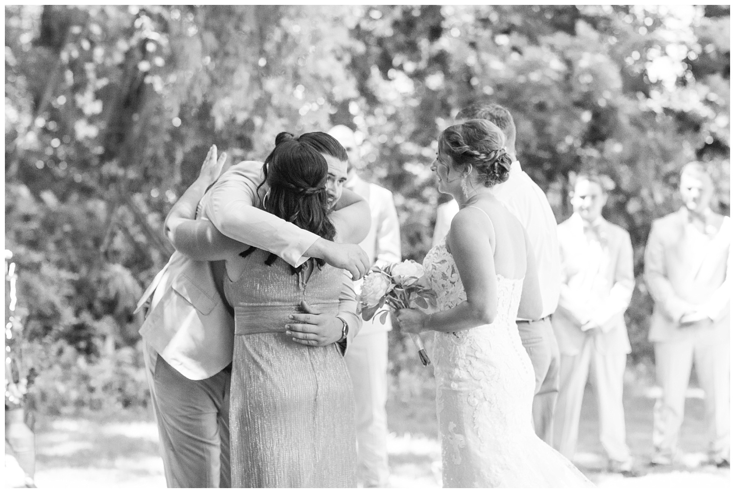 groom hugging the mom of the bride