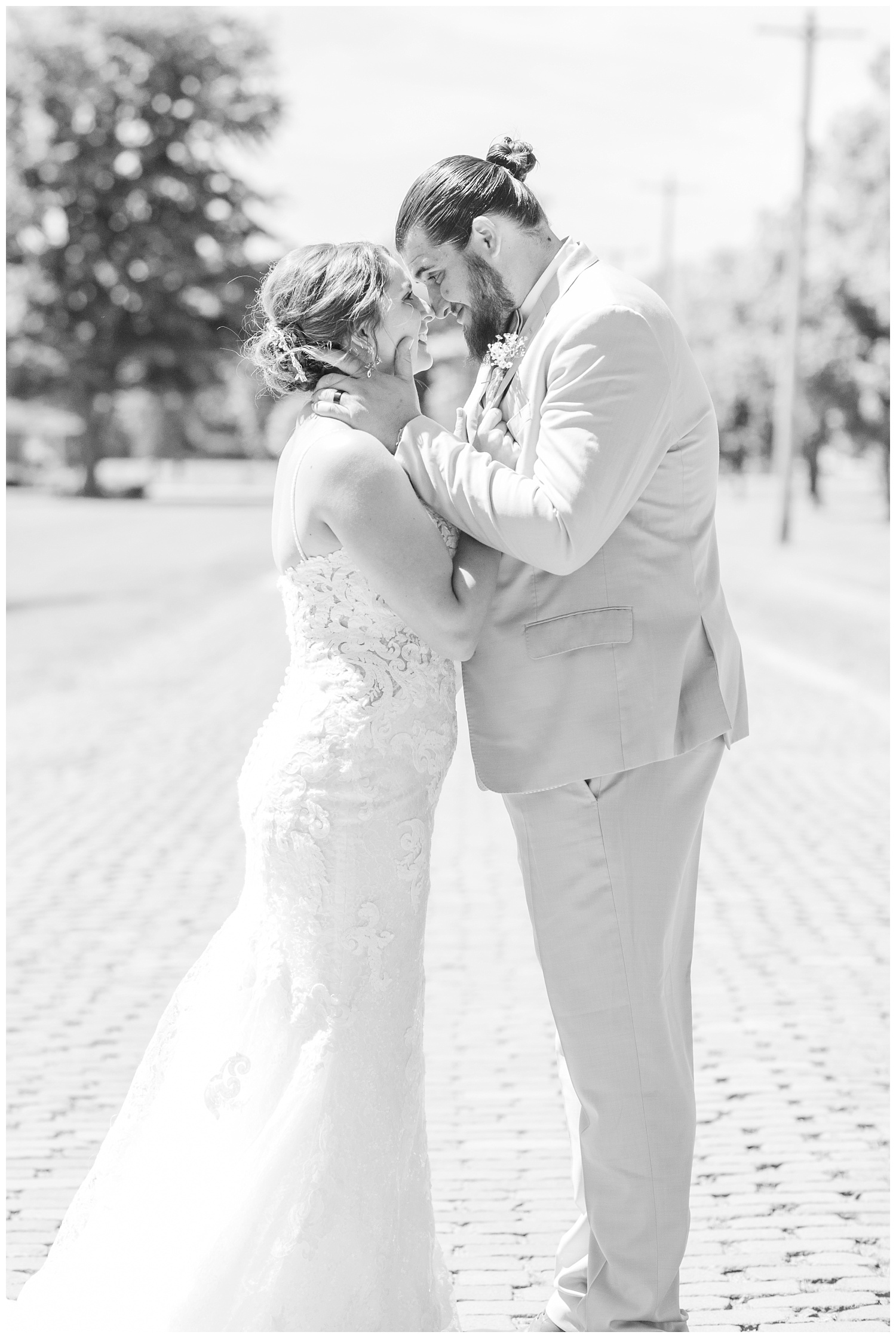 bride and groom kissing on a brick street in Ohio