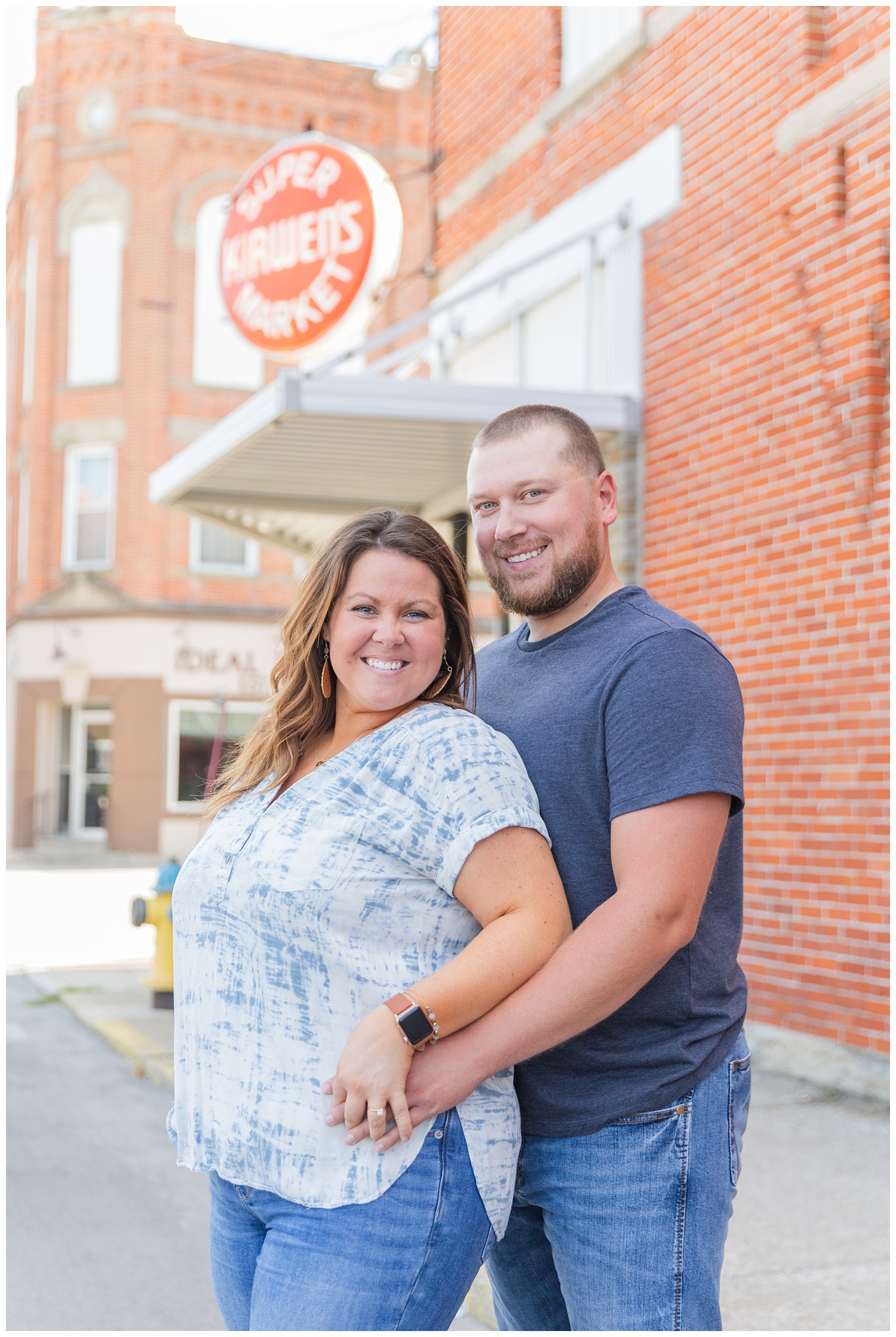 couple standing in front of Kirwen's grocery store sign in Ohio