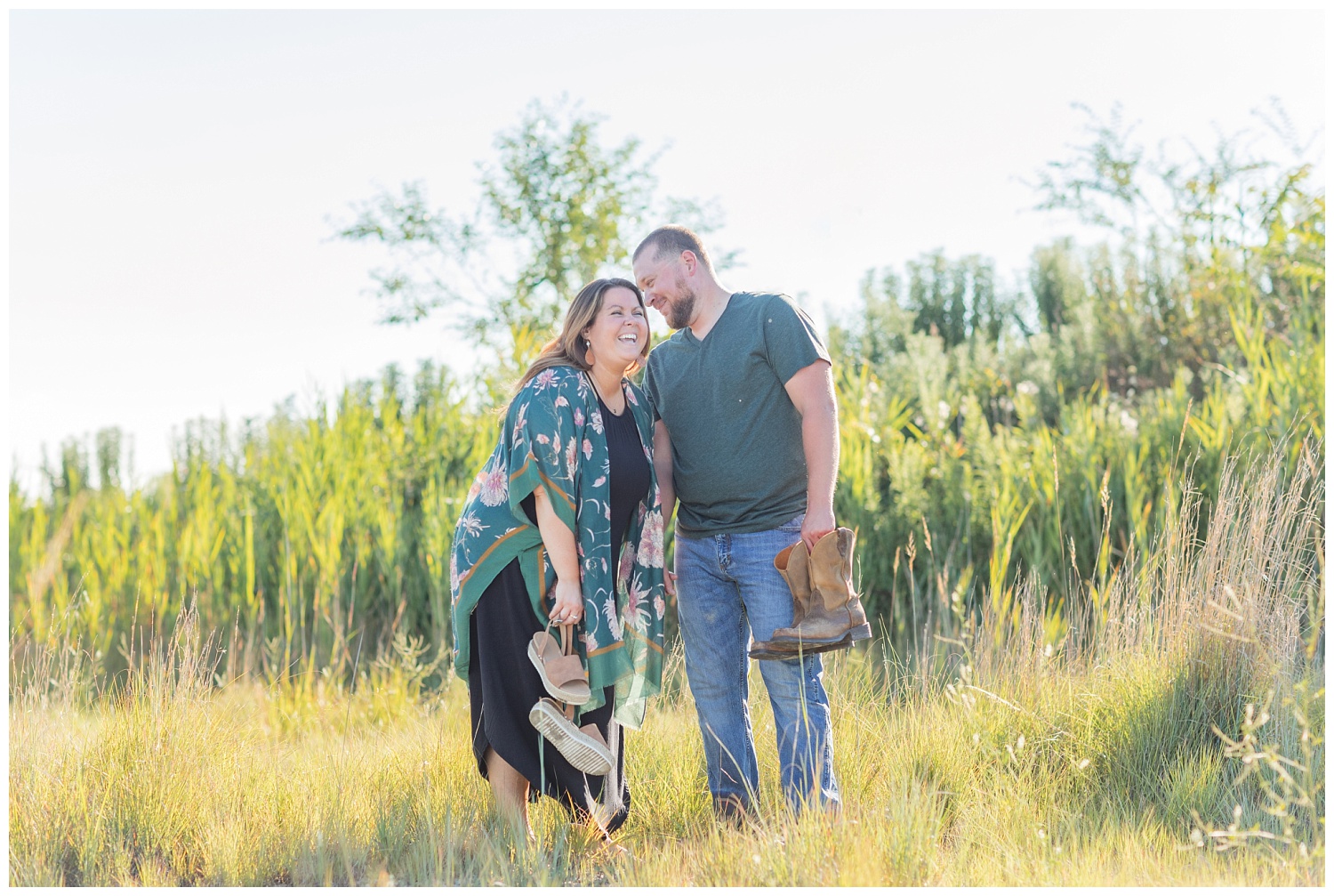 couple holding their shoes and laughing during engagement session in Ohio
