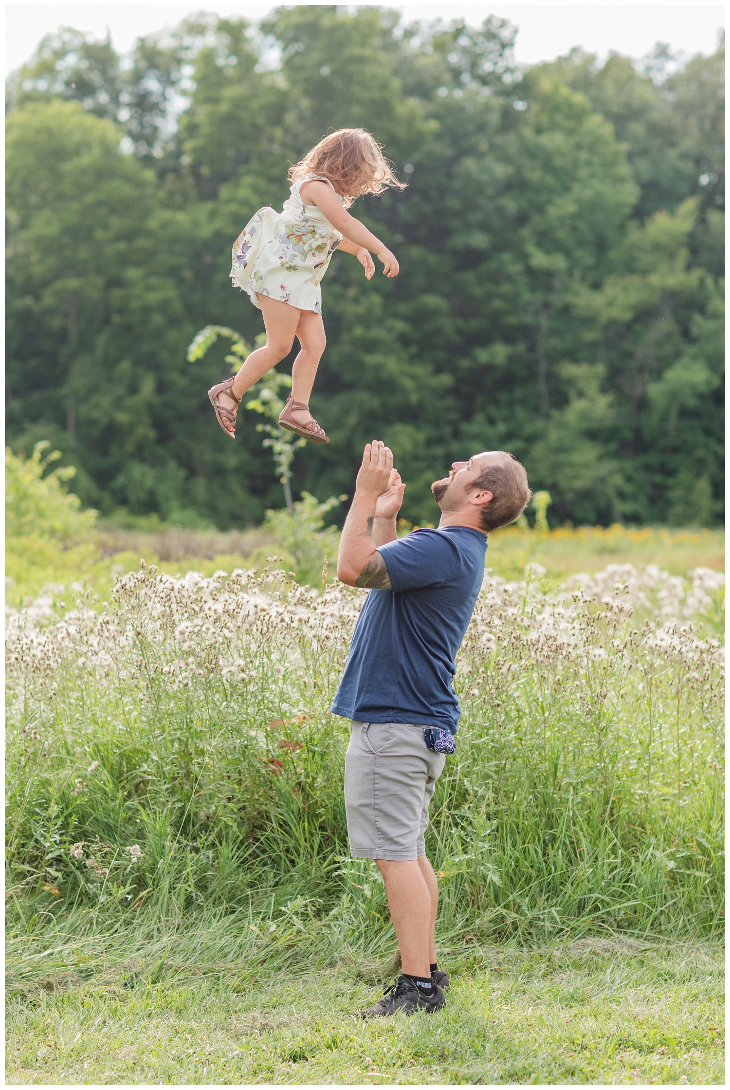 dad throwing his daughter in the air at birthday session