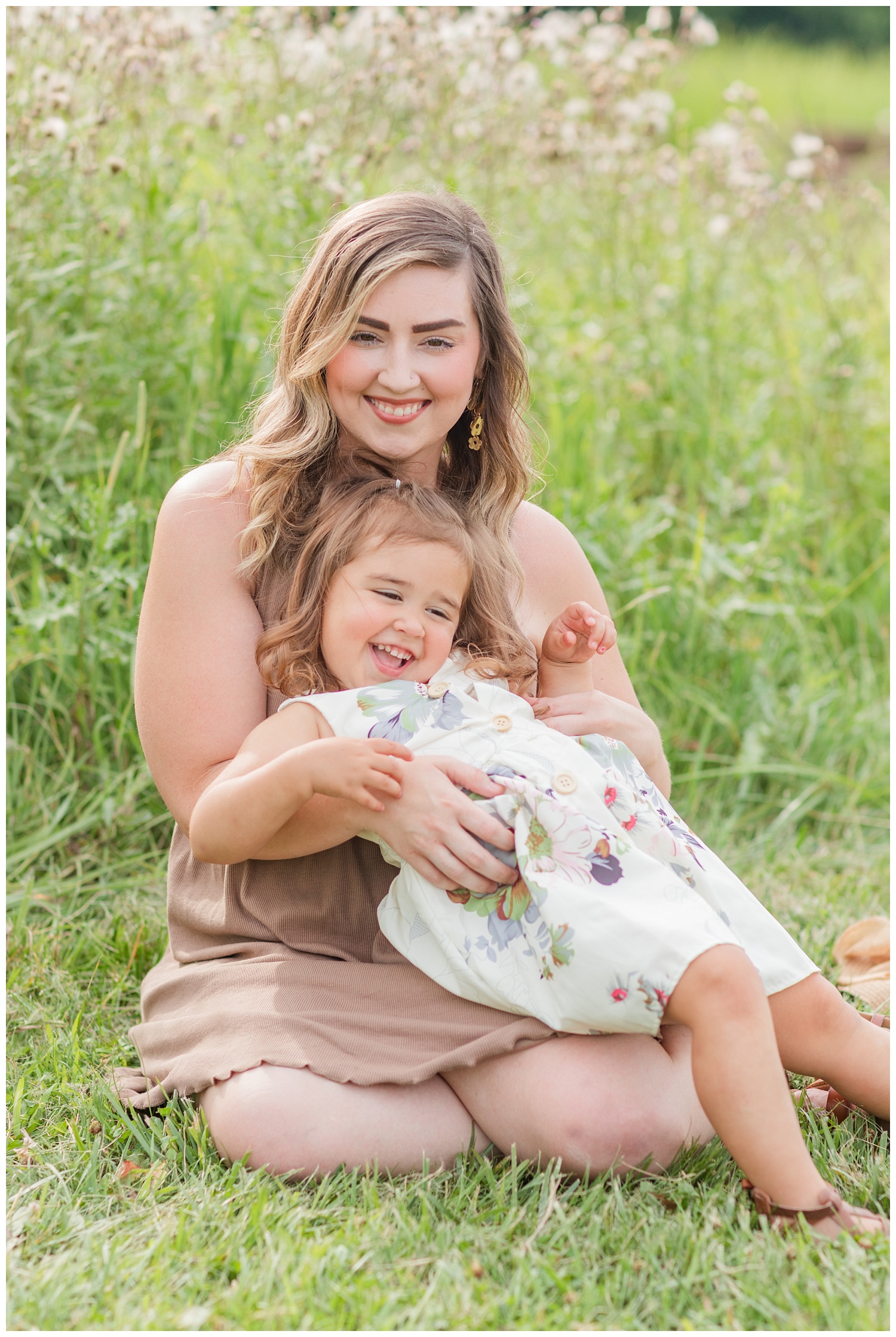 mom sitting with her little girl at birthday photo session