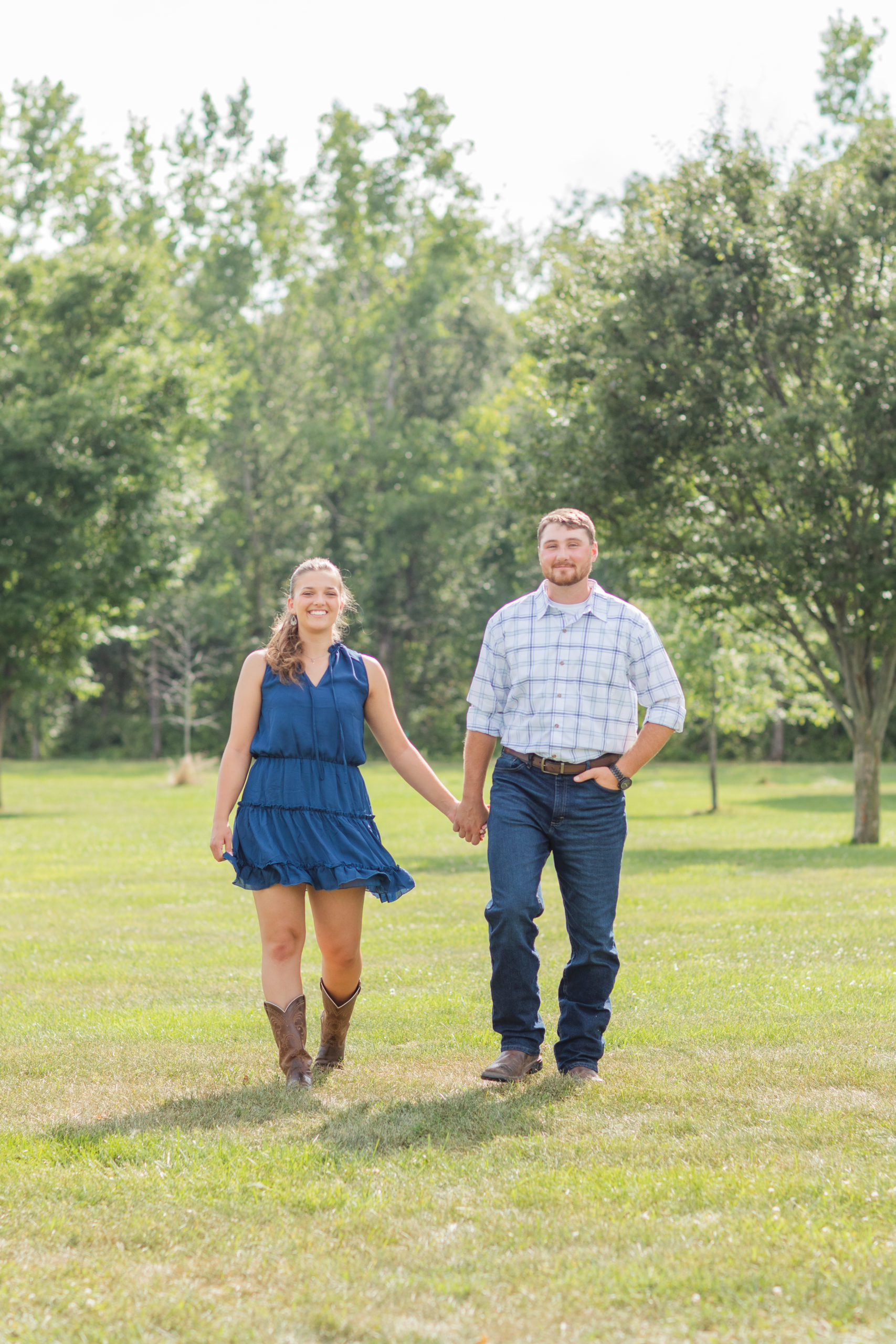 couple holding hands and walking at engagement session