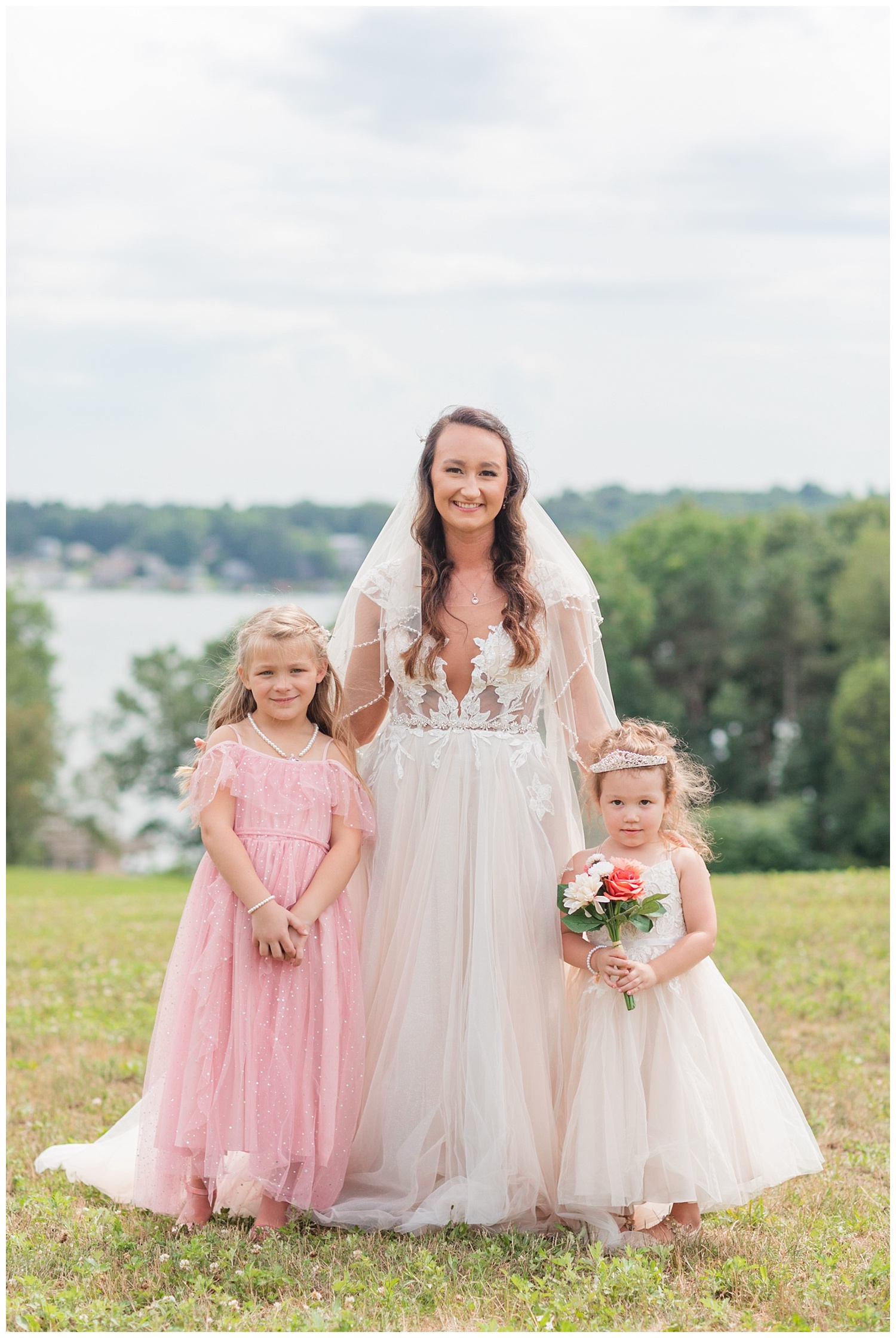 bride posing with flower girls at the lake in Ohio