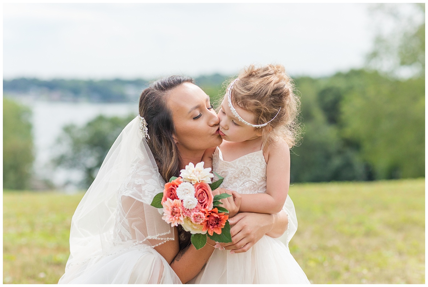 bride kissing her flower girl at wedding in Ohio
