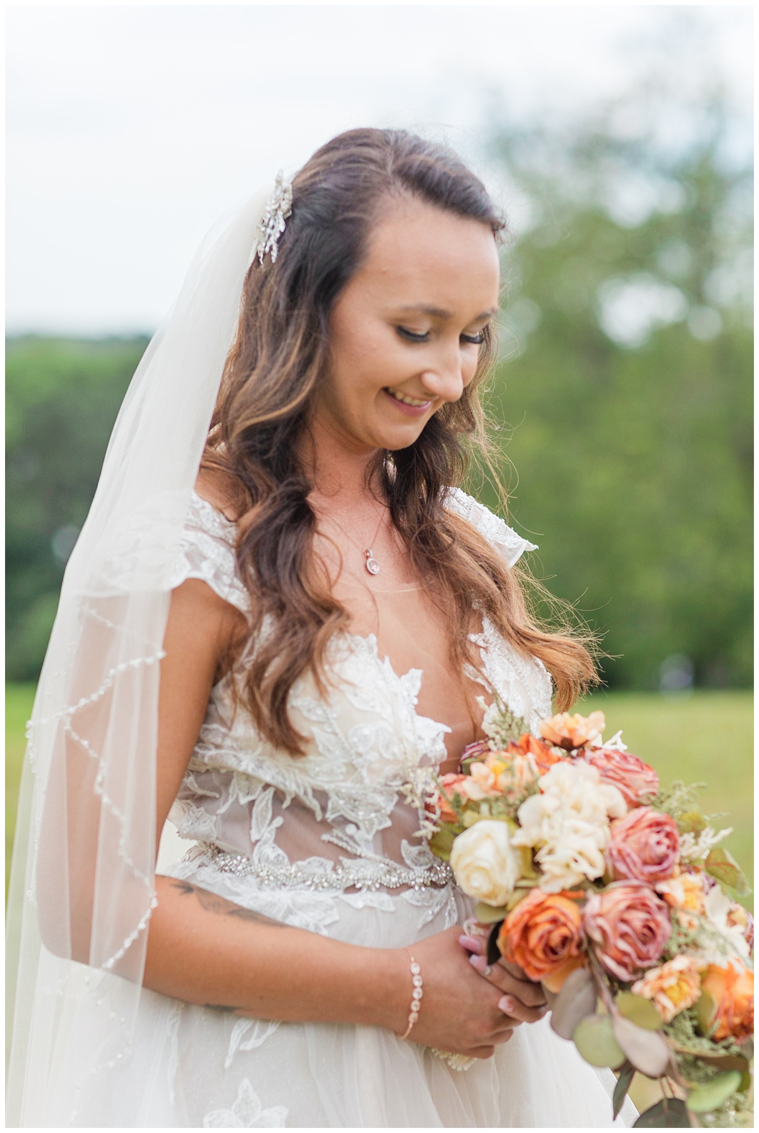 bride looking down at her wedding flowers 