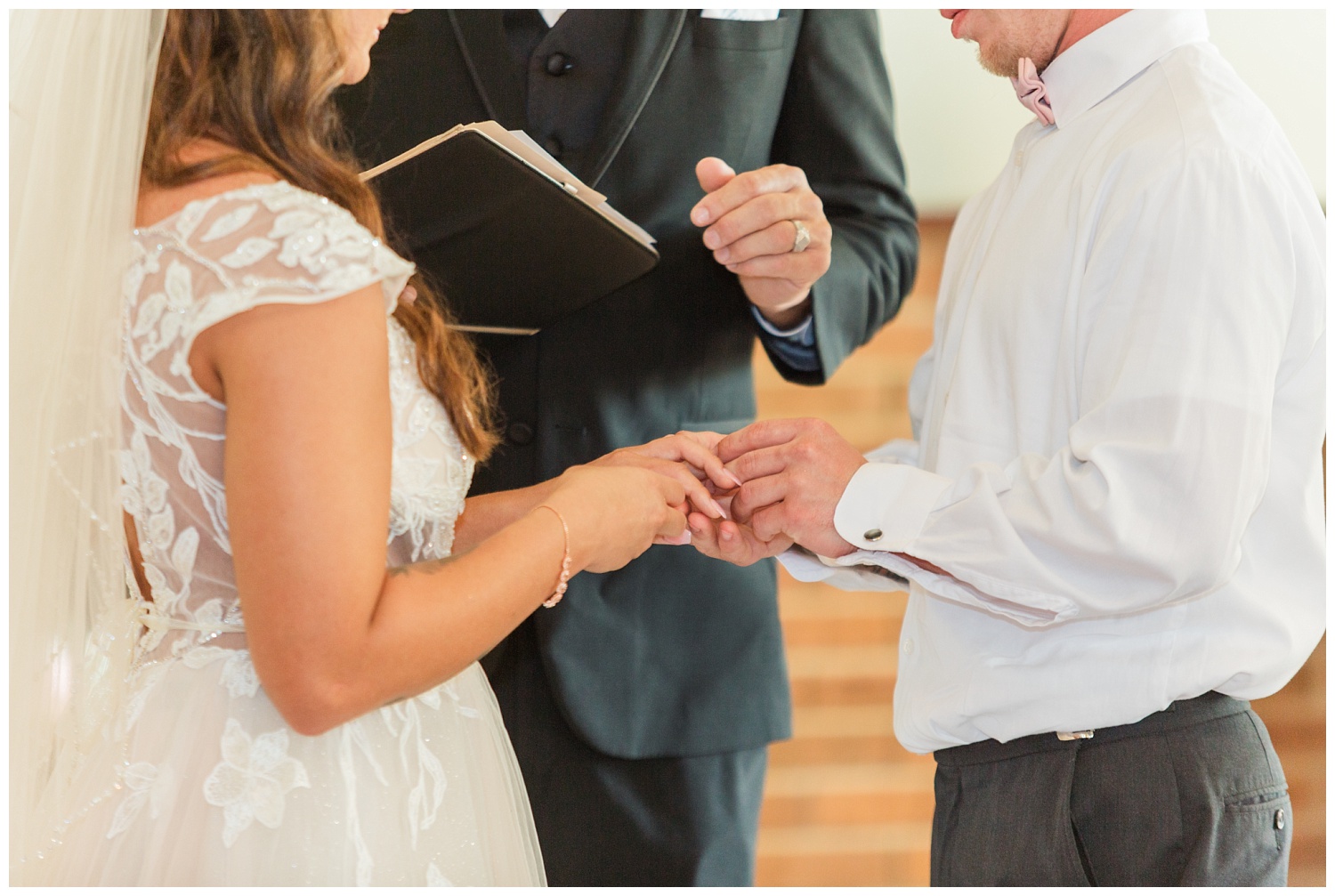 bride and groom exchanging rings at wedding in Ohio