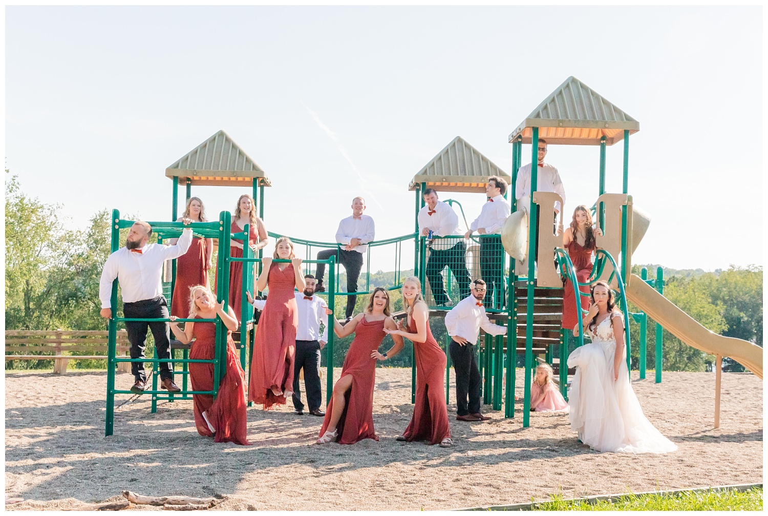 full bridal party standing on the playground at Apple Valley Lake