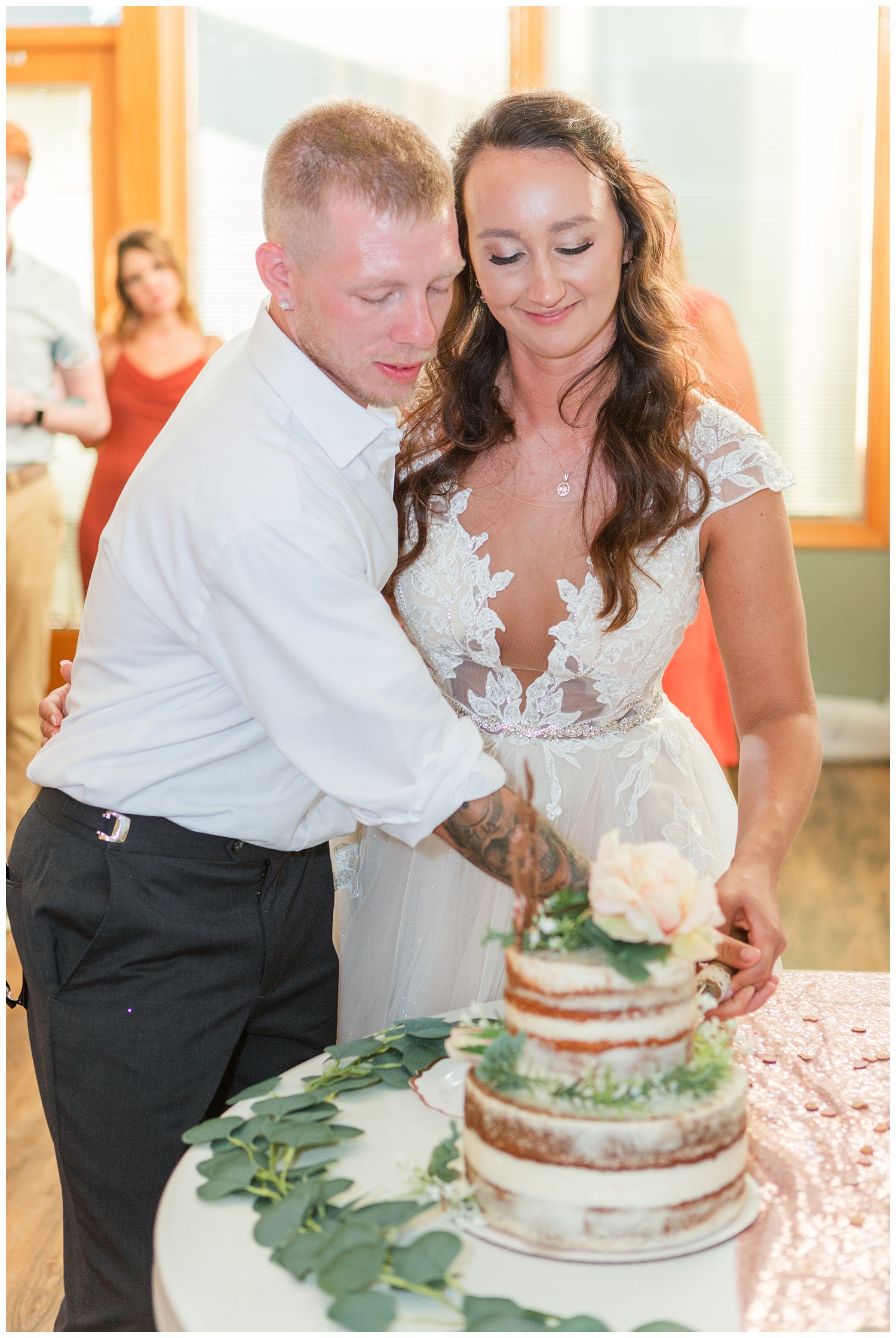bride and groom cutting their cake at Apple Valley Lake